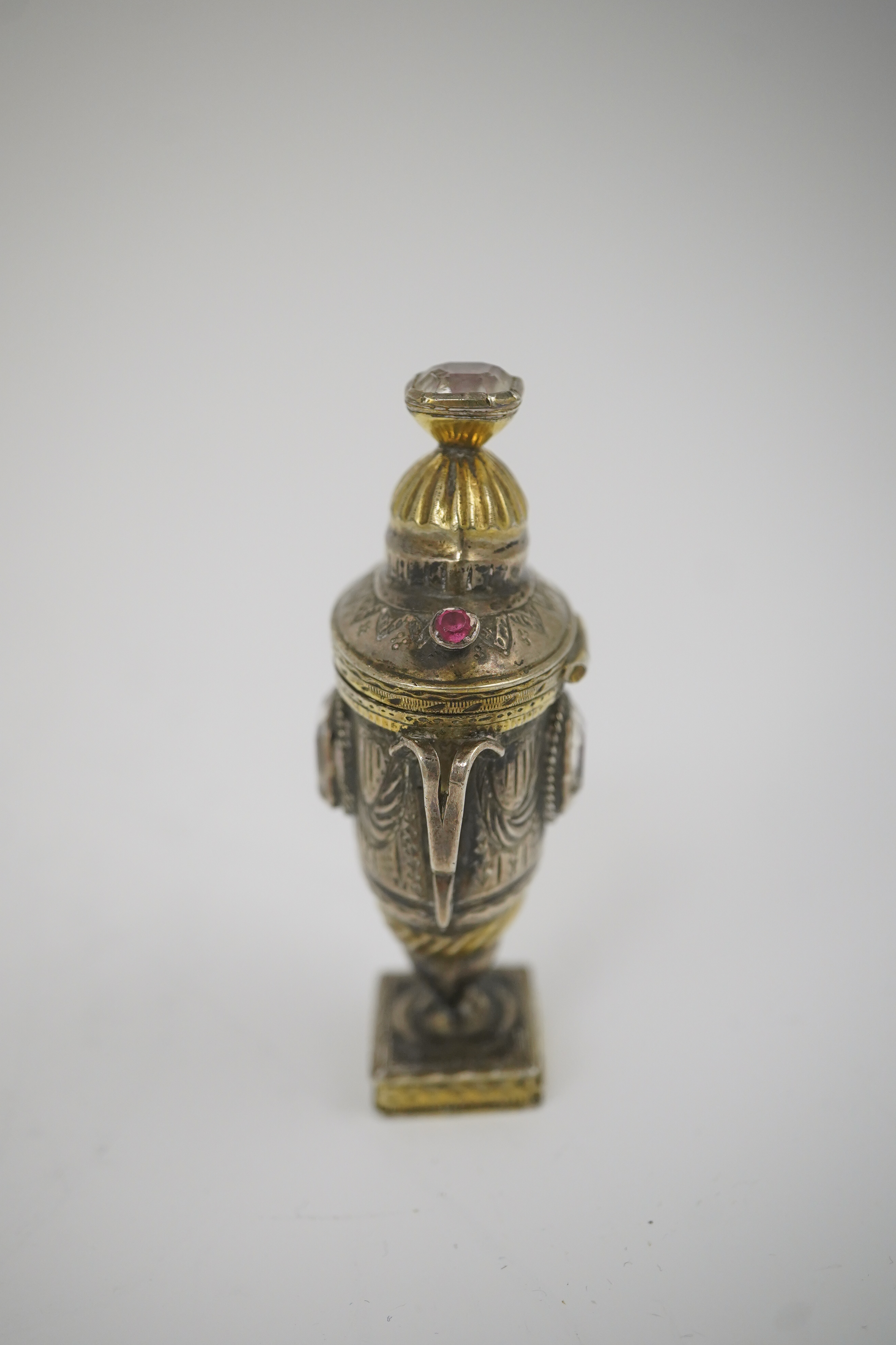 A 19th century continental parcel gilt silver and gem set double ended pill box, modelled as a two handle vase